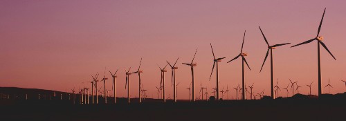 Wind turbines on a hill at sunset